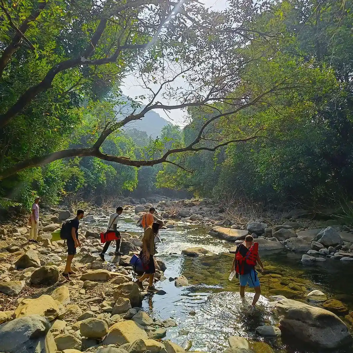 A group of men crossing a river, each step symbolising transformation and renewal at Borderlands